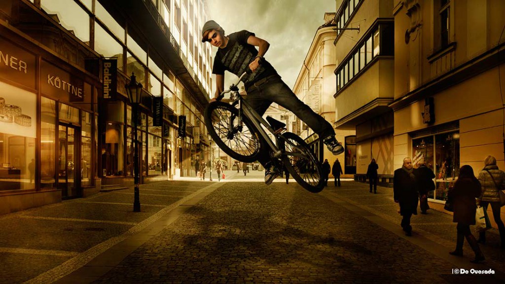 Galería de fotografía, el muchacho que salta con la bicicleta en el medio de la calle